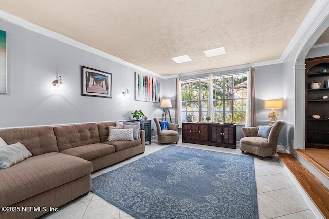 living room featuring light tile patterned floors, a textured ceiling, and crown molding