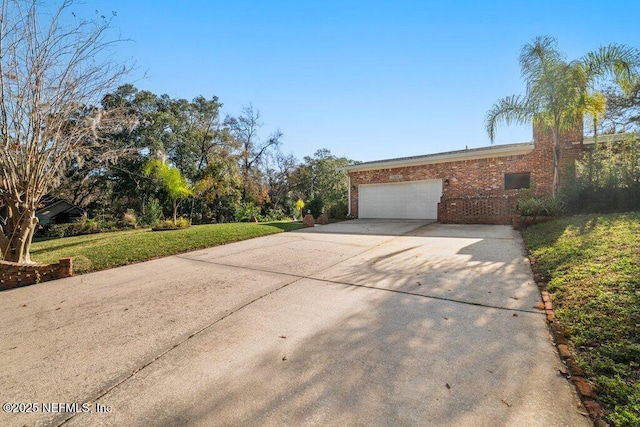 view of front of house with a front yard and a garage