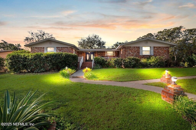 ranch-style house featuring a lawn