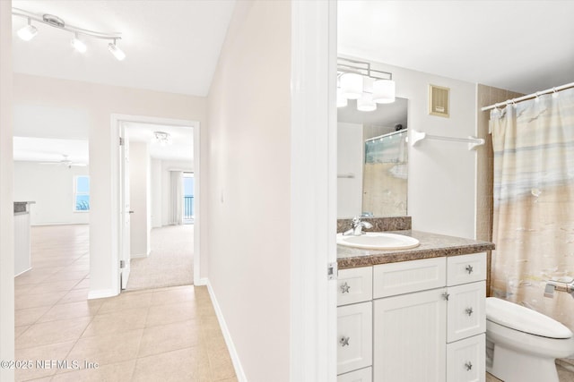 bathroom with ceiling fan, a shower with curtain, tile patterned flooring, toilet, and vanity