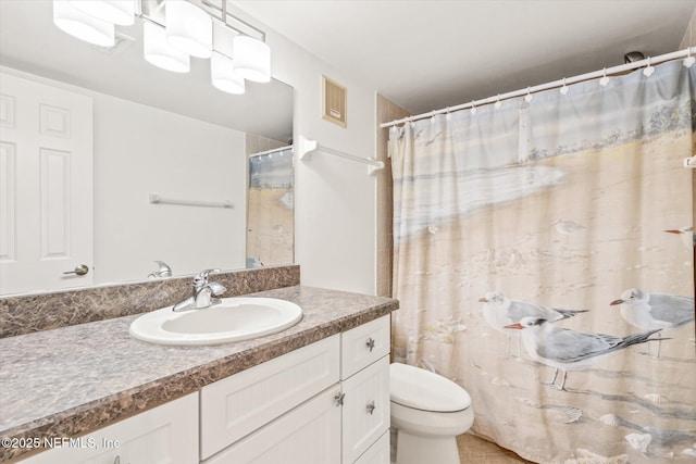 bathroom featuring tile patterned flooring, vanity, and toilet