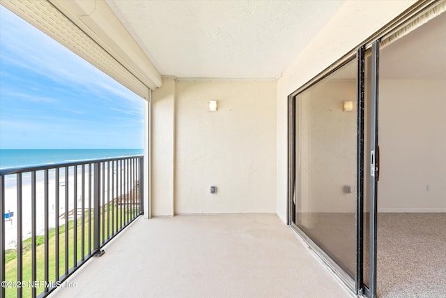 balcony with a view of the beach and a water view