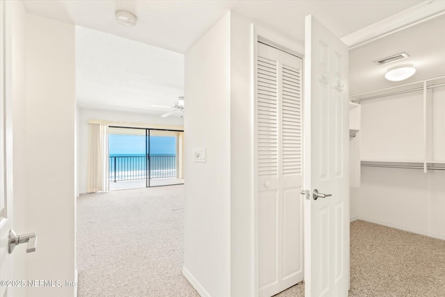 hallway featuring light colored carpet