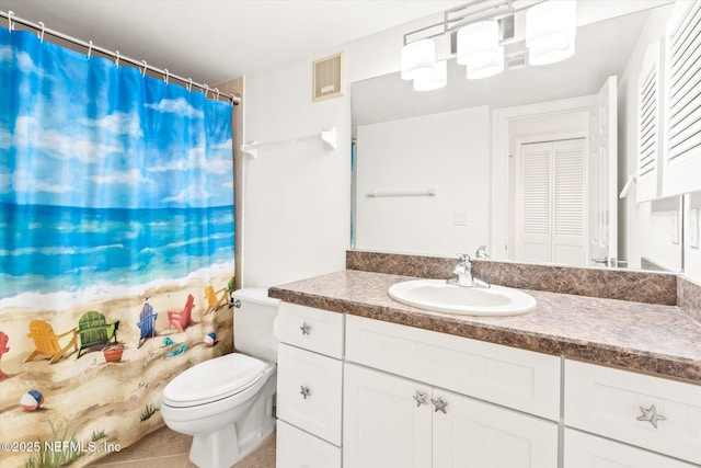 bathroom featuring tile patterned floors, vanity, and toilet