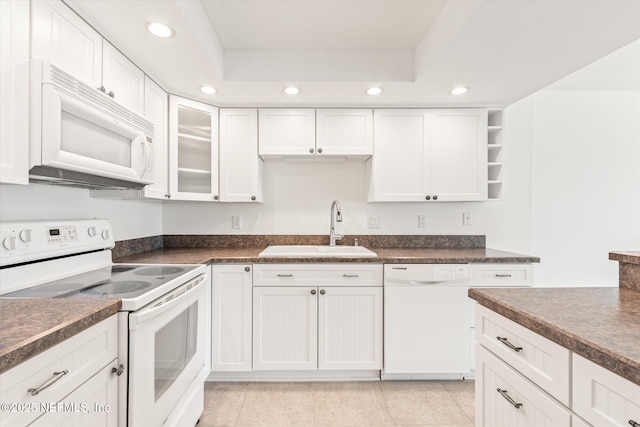 kitchen featuring white cabinets, white appliances, and sink