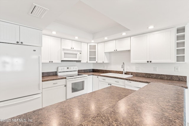 kitchen featuring white cabinetry, white appliances, and sink