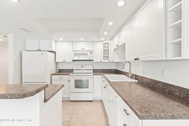 kitchen with white appliances, white cabinetry, and sink