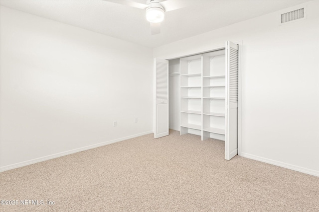 unfurnished bedroom with ceiling fan, light colored carpet, and a closet