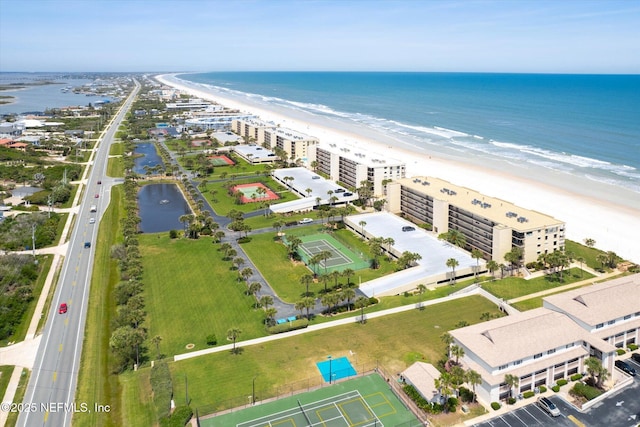 drone / aerial view with a water view and a view of the beach