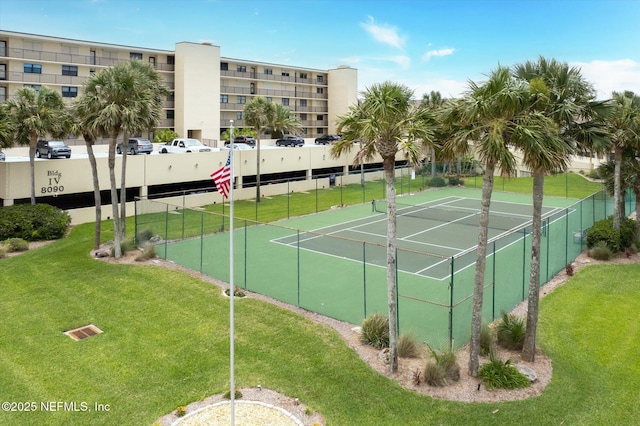 view of sport court with a lawn