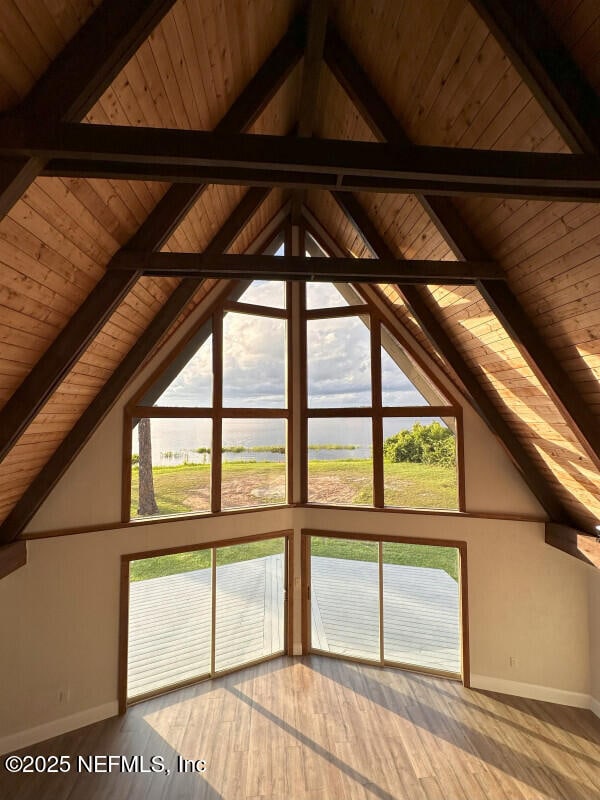 bonus room featuring vaulted ceiling with beams, plenty of natural light, wood ceiling, and hardwood / wood-style flooring