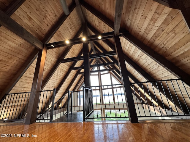 additional living space with lofted ceiling with beams, dark wood-type flooring, and wood ceiling