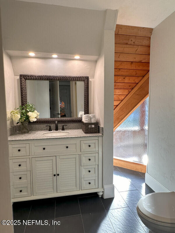 bathroom with tile patterned floors, vanity, and toilet