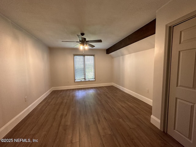 empty room with ceiling fan, dark hardwood / wood-style flooring, and vaulted ceiling