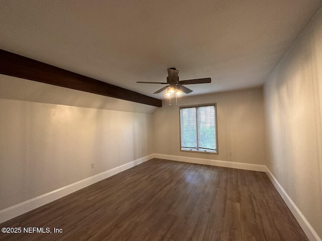 spare room with lofted ceiling with beams, dark hardwood / wood-style floors, and ceiling fan