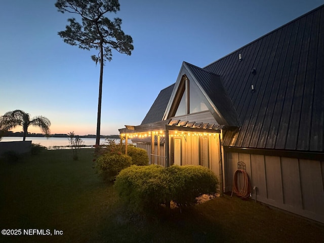 property exterior at dusk with a water view