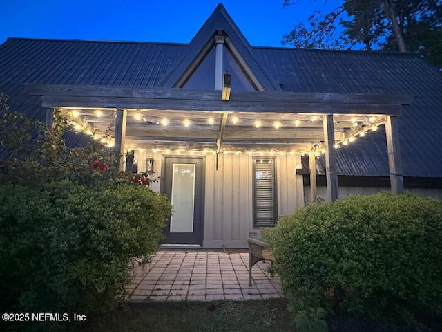 view of exterior entry at night