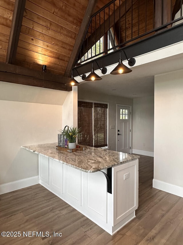 kitchen featuring light stone countertops, wood ceiling, white cabinets, vaulted ceiling with beams, and dark hardwood / wood-style floors