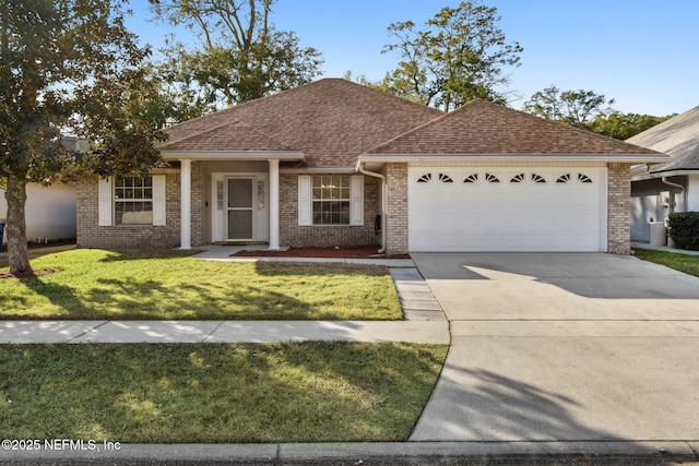 single story home featuring a garage and a front lawn