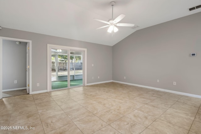 tiled spare room with vaulted ceiling and ceiling fan