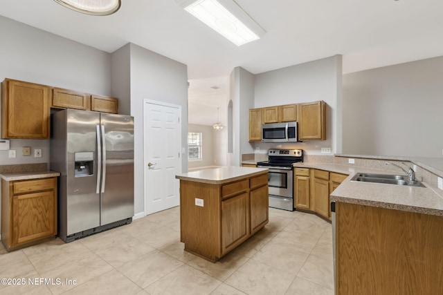 kitchen featuring a kitchen island, sink, light tile patterned floors, kitchen peninsula, and stainless steel appliances