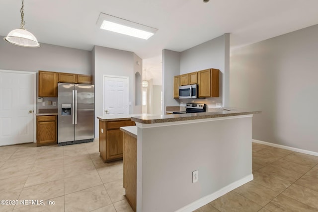 kitchen with pendant lighting, light tile patterned floors, stainless steel appliances, and kitchen peninsula