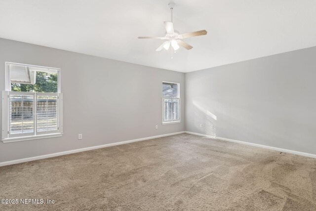 carpeted spare room with ceiling fan