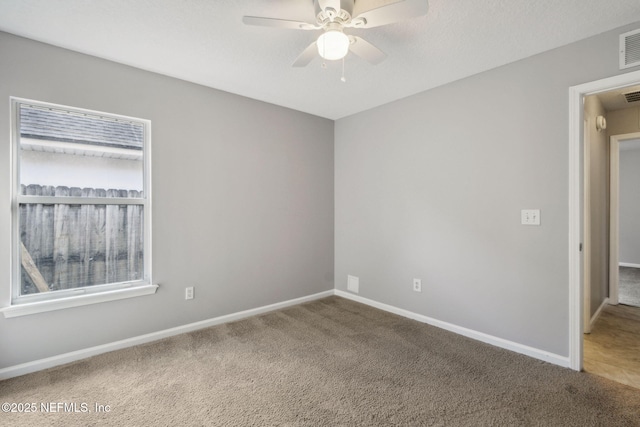 empty room featuring carpet flooring and ceiling fan