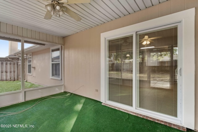 unfurnished sunroom with ceiling fan