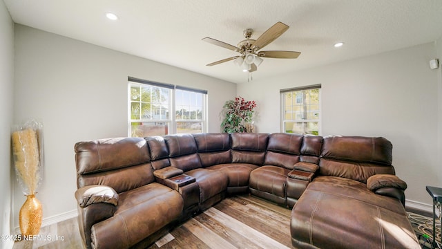 living room featuring light wood-type flooring and ceiling fan