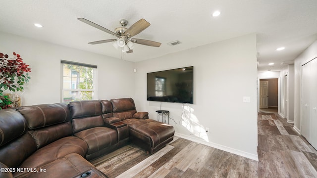 living room featuring light hardwood / wood-style flooring and ceiling fan