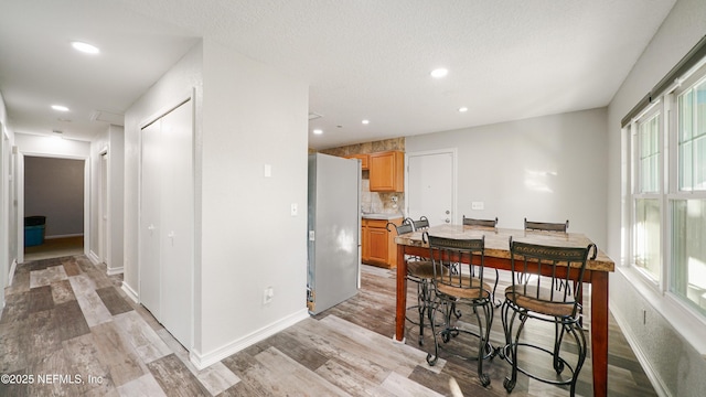 dining space featuring light wood-type flooring