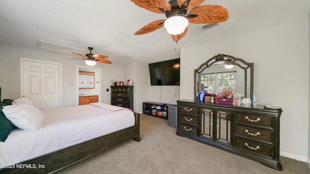 bedroom featuring connected bathroom, ceiling fan, light colored carpet, and a textured ceiling