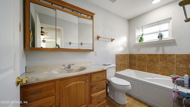 bathroom with vanity, tile patterned floors, toilet, a textured ceiling, and a tub