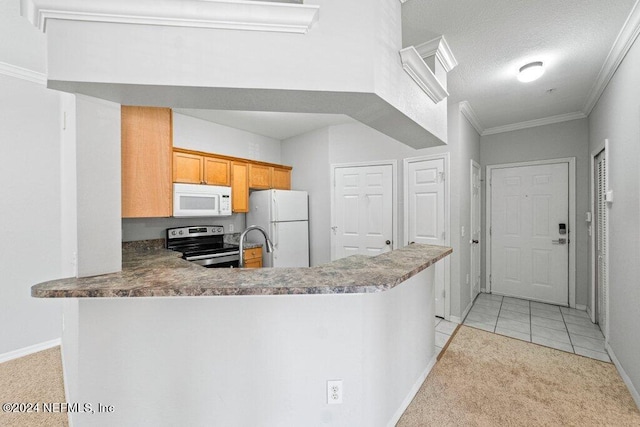 kitchen with a textured ceiling, kitchen peninsula, light tile patterned flooring, and white appliances