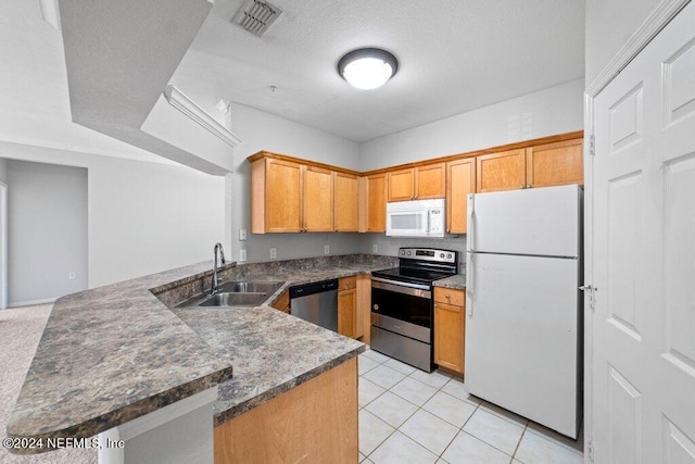 kitchen with kitchen peninsula, a textured ceiling, stainless steel appliances, sink, and light tile patterned floors