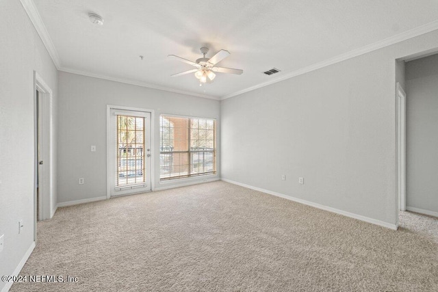 carpeted empty room with ceiling fan and ornamental molding