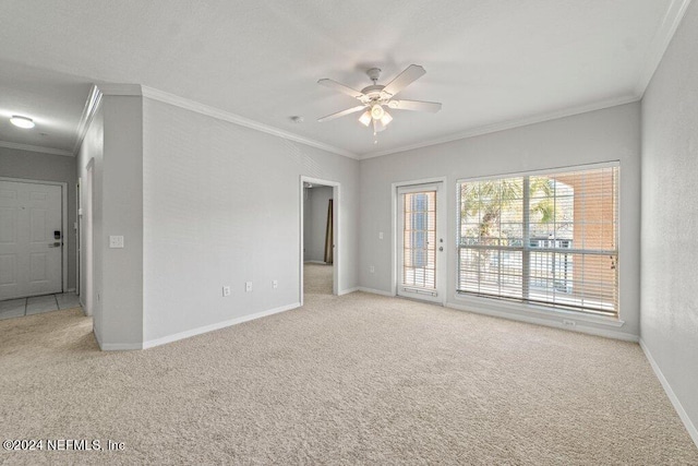 spare room with light carpet, crown molding, and ceiling fan