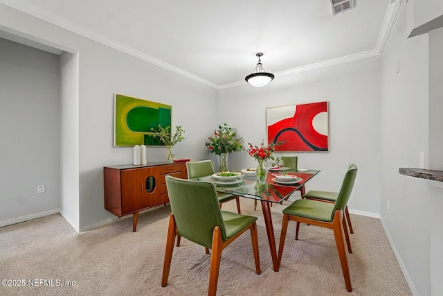 dining room with light colored carpet and ornamental molding