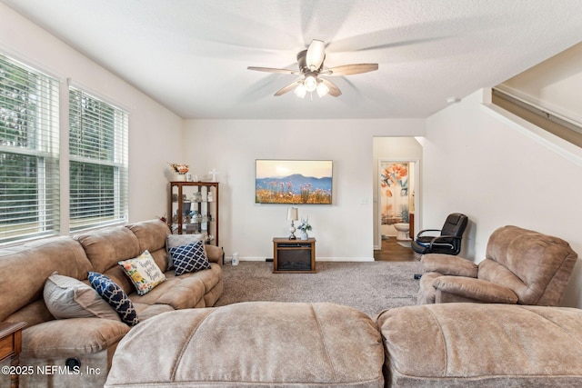 living room featuring ceiling fan and carpet