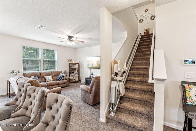 carpeted living room featuring a textured ceiling and ceiling fan