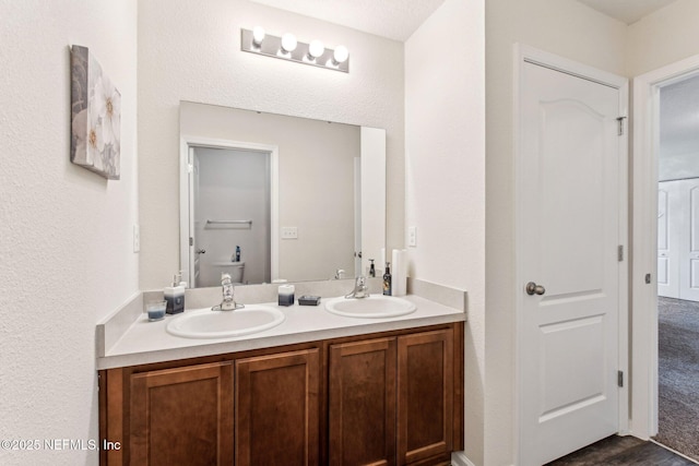 bathroom with hardwood / wood-style floors and vanity