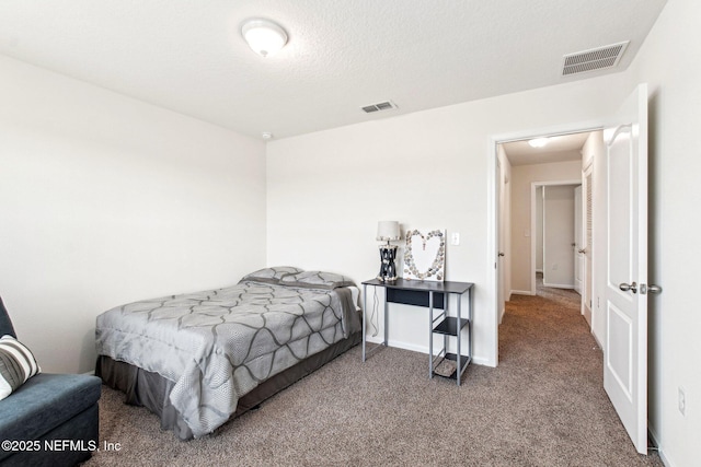 carpeted bedroom with a textured ceiling