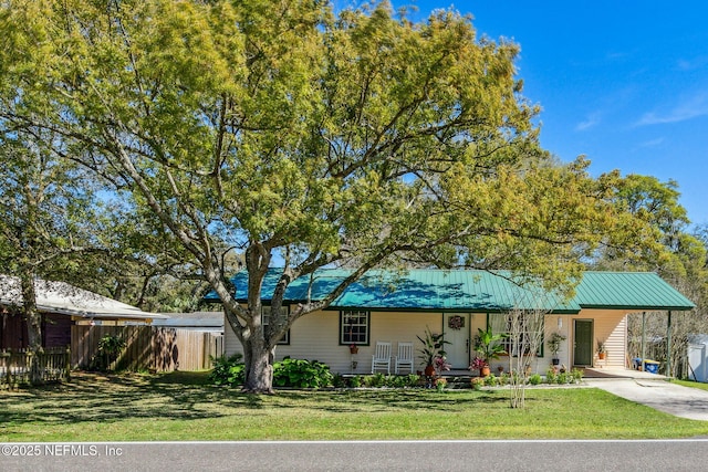 view of front of property with a carport, covered porch, and a front lawn