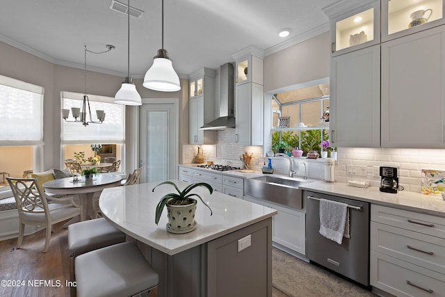 kitchen featuring stainless steel appliances, a kitchen island, white cabinets, and wall chimney exhaust hood