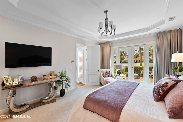 bedroom featuring access to exterior, a tray ceiling, ornamental molding, and french doors