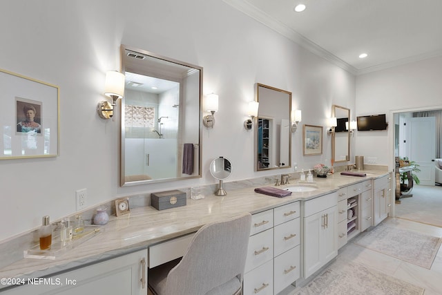 bathroom featuring a shower with door, ornamental molding, and vanity