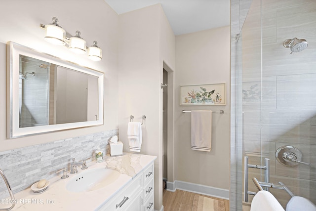 bathroom with vanity, backsplash, and walk in shower