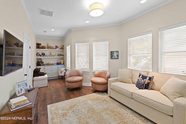 living room featuring ornamental molding, plenty of natural light, dark hardwood / wood-style flooring, and built in shelves