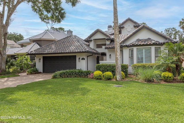 view of front of house with a garage and a front yard